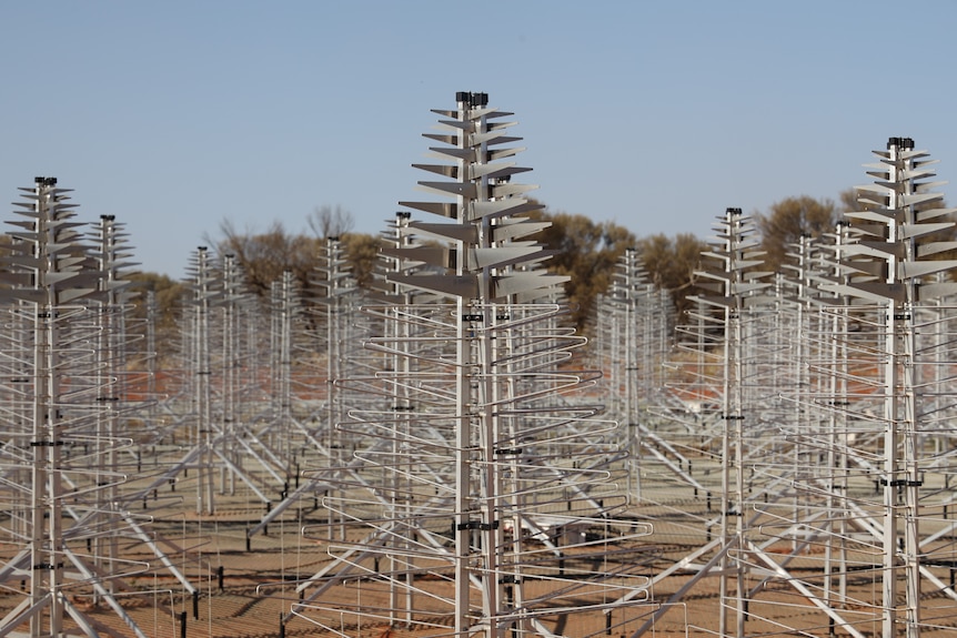 Antennas in the shape of a Christmas tree in the form of a grid in the desert.